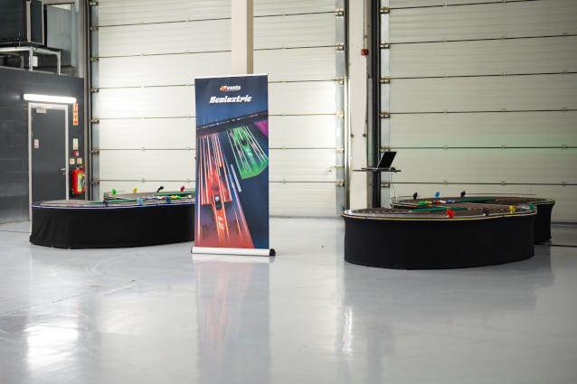 Two scalextric tracks on display in a large room.