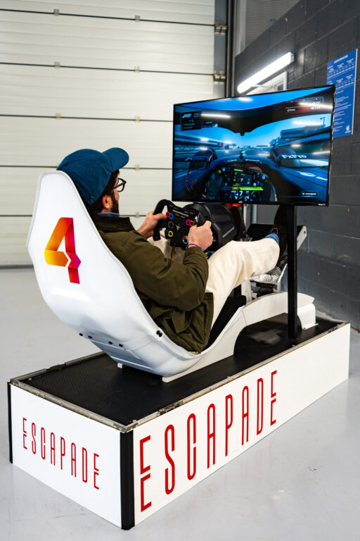 A man playing a racing simulator game.